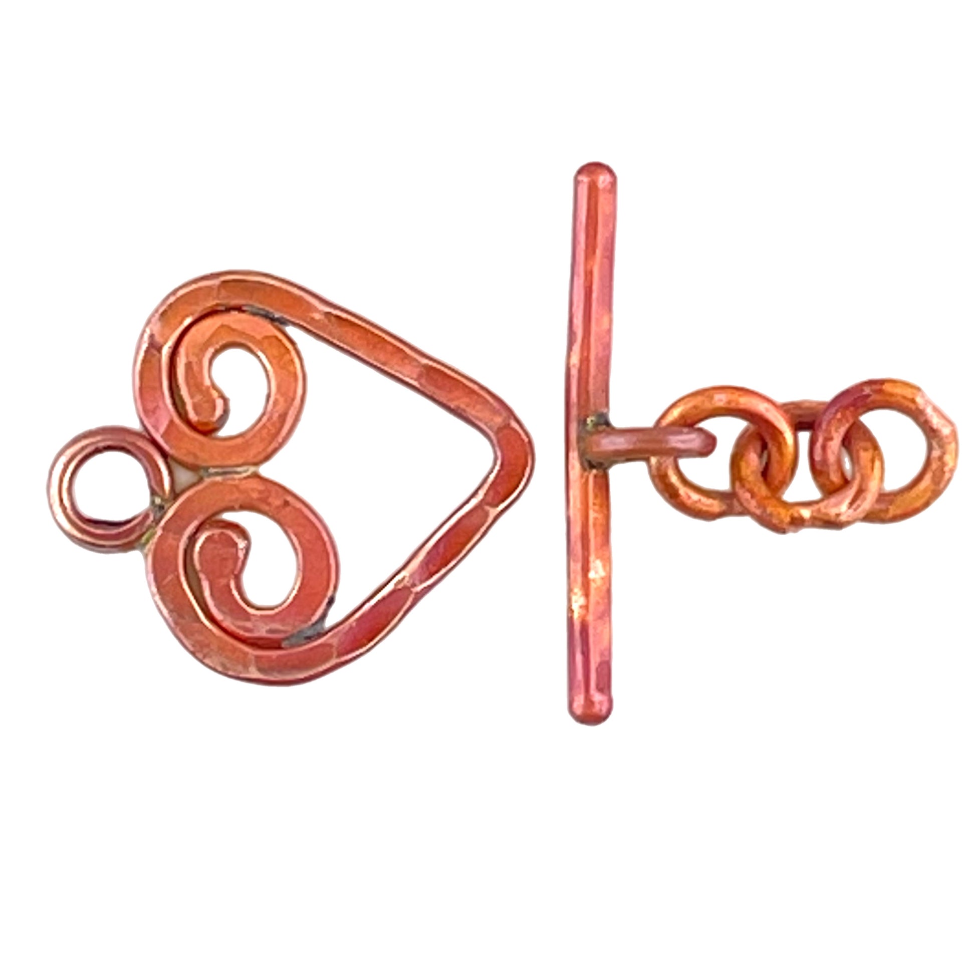 Hand-hammered copper heart toggle clasp with a textured surface and a separate bar and lead chain component.