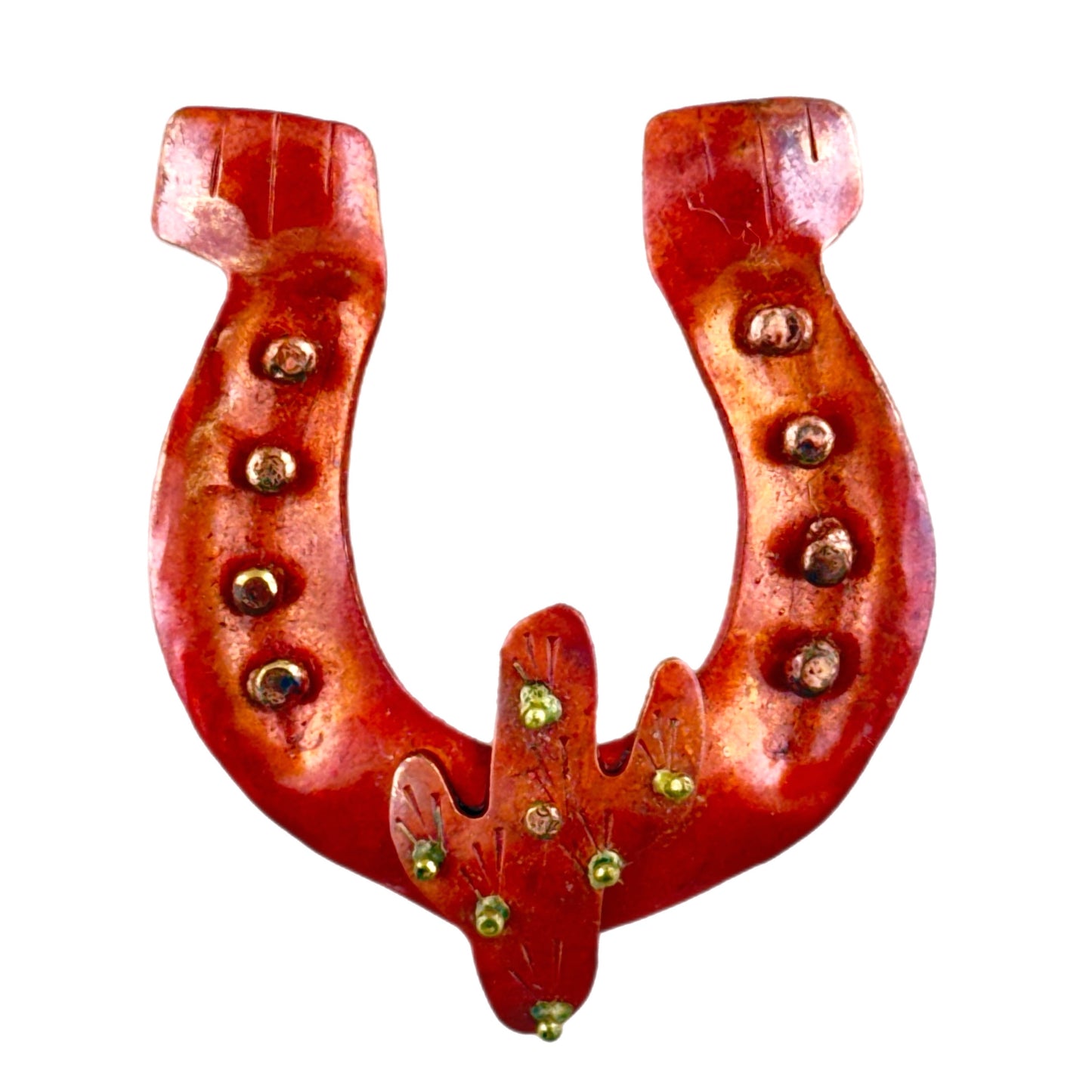 Copper horseshoe pendant with saguaro cactus accent, rustic texture, and brass stud details. Western necklace focal in red-orange patina with handcrafted finish.