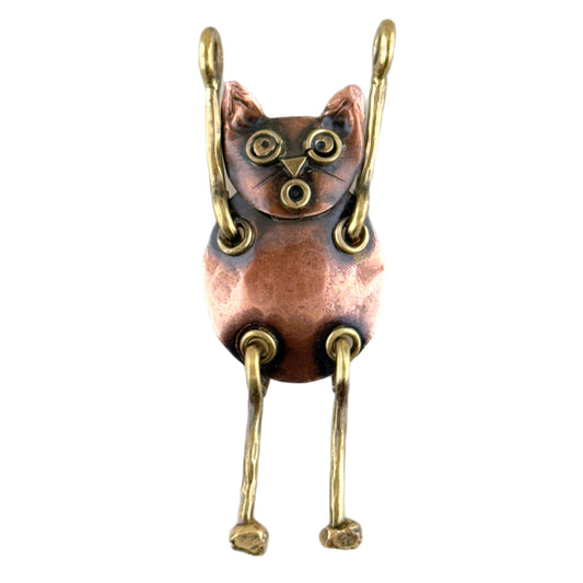 Leaping copper cat pendant with outstretched paws, brass accents, and antique patina, handcrafted by Patricia Healey using repoussé technique.