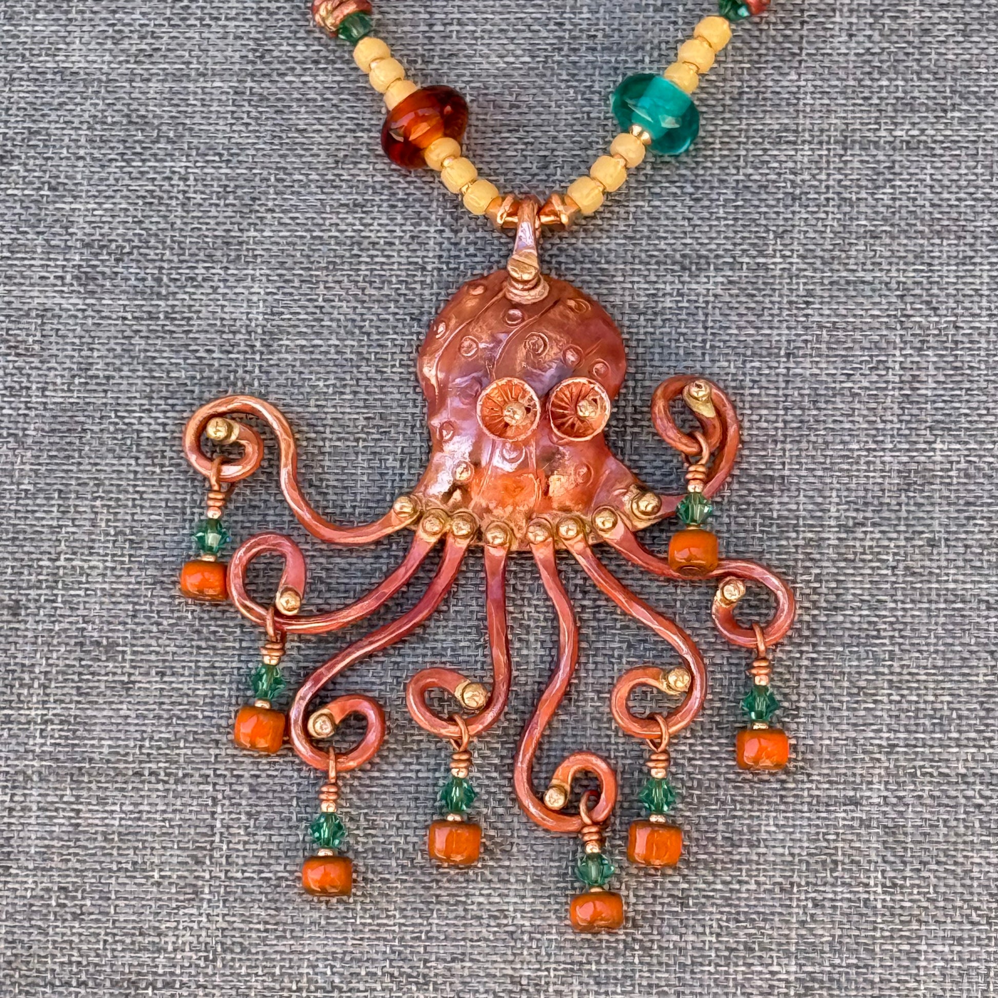 Handcrafted copper octopus necklace with artisan glass and Japanese seed beads in ocean-inspired colors