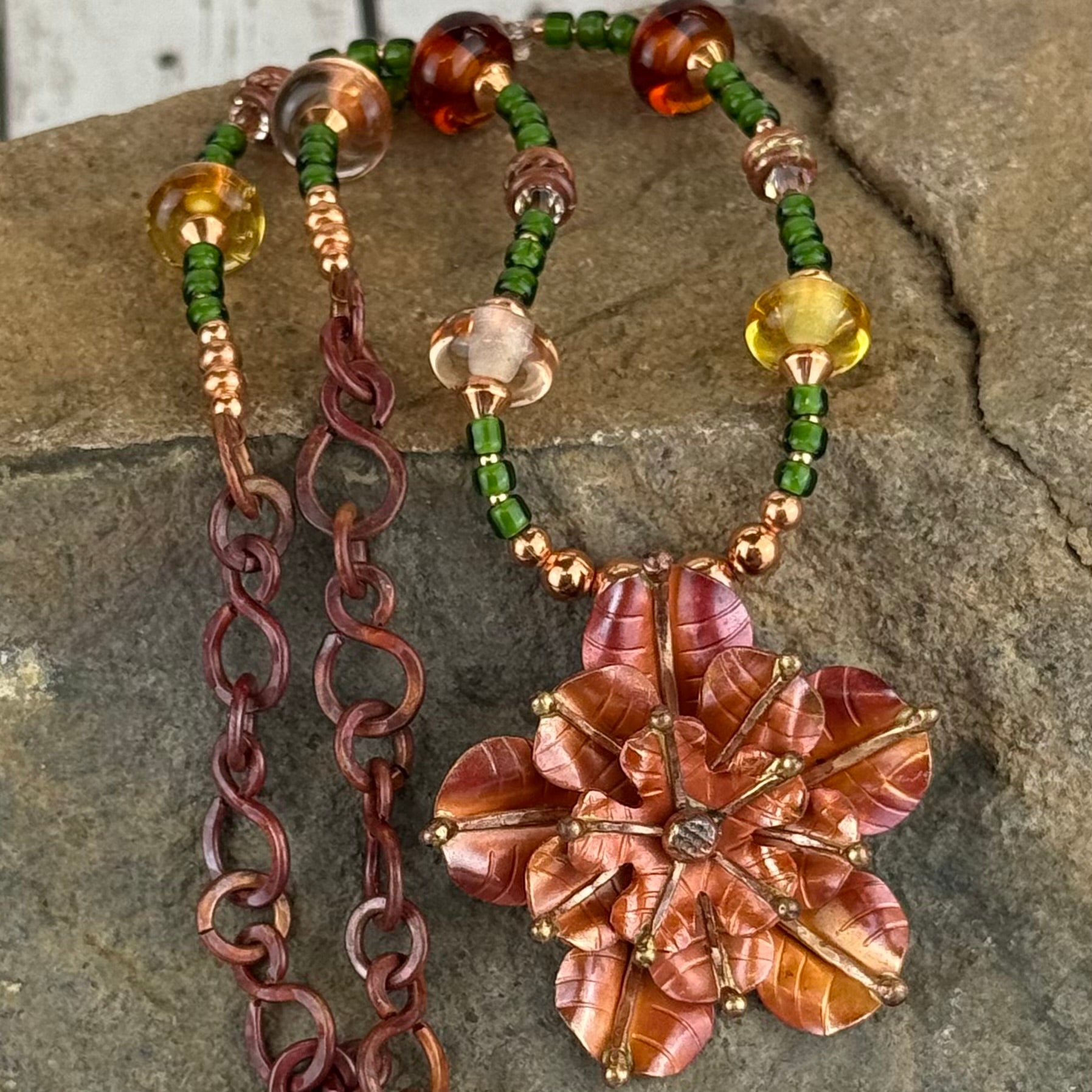 Elizabeth rose pendant necklace with green dichroic seed beads, Swarovski crystals, and rustic copper chain