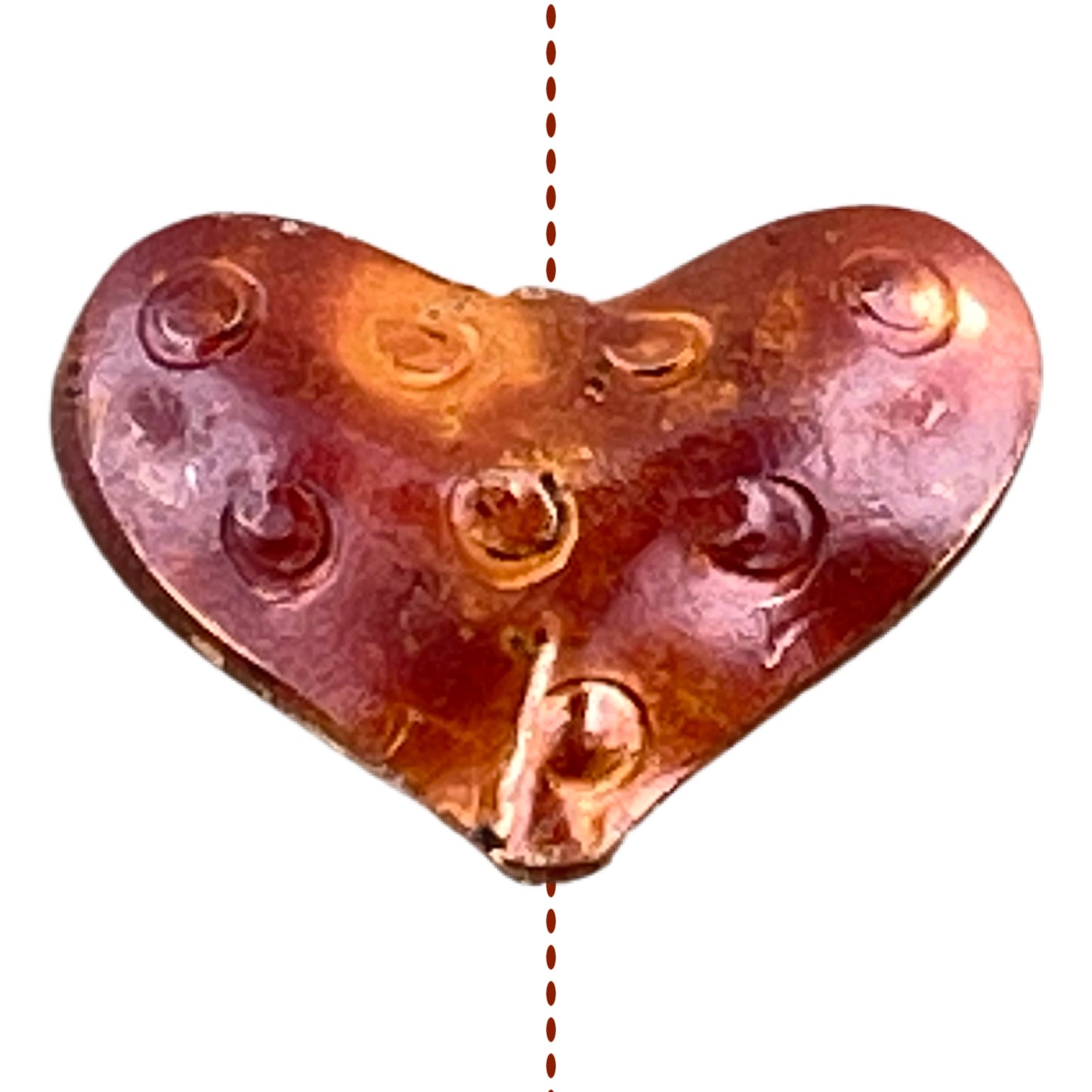 Small copper heart bead with stamped design and orange-red flame patina