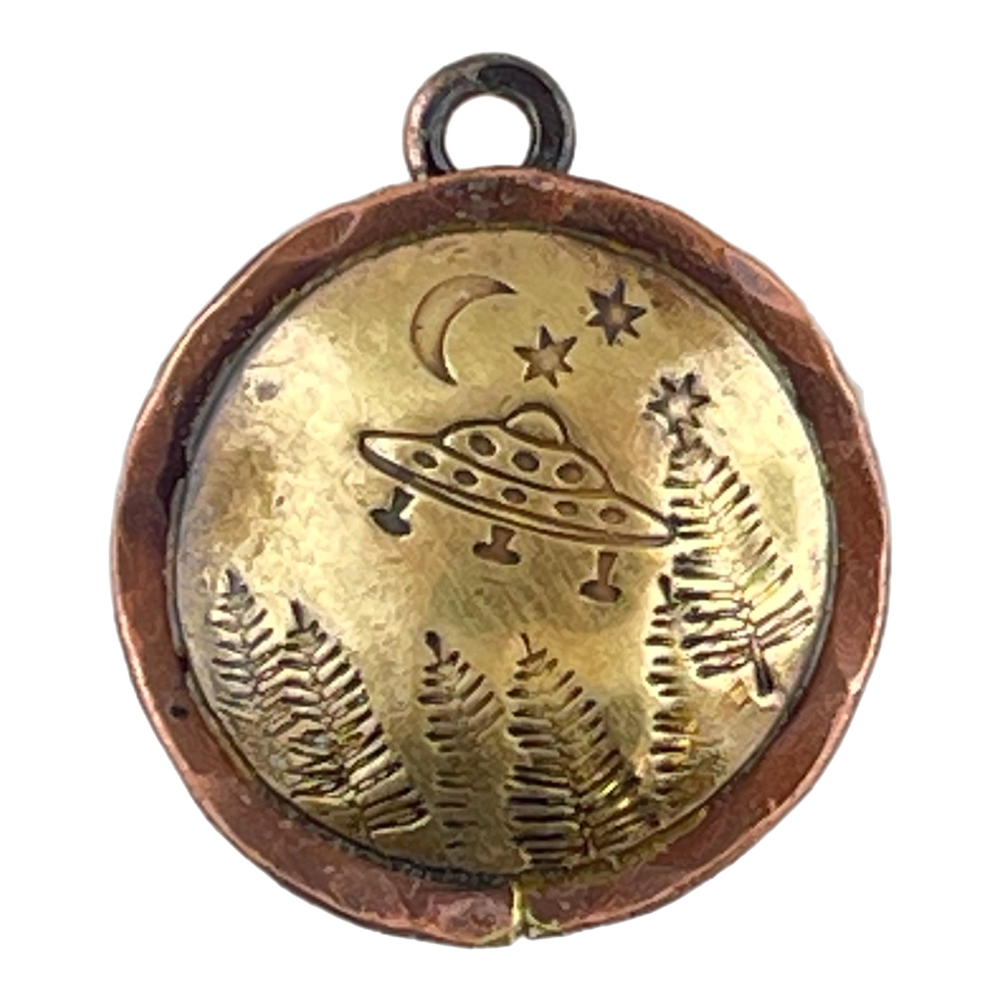 Hand-stamped copper and brass charm with domed brass base featuring a spaceship hovering over forest design
