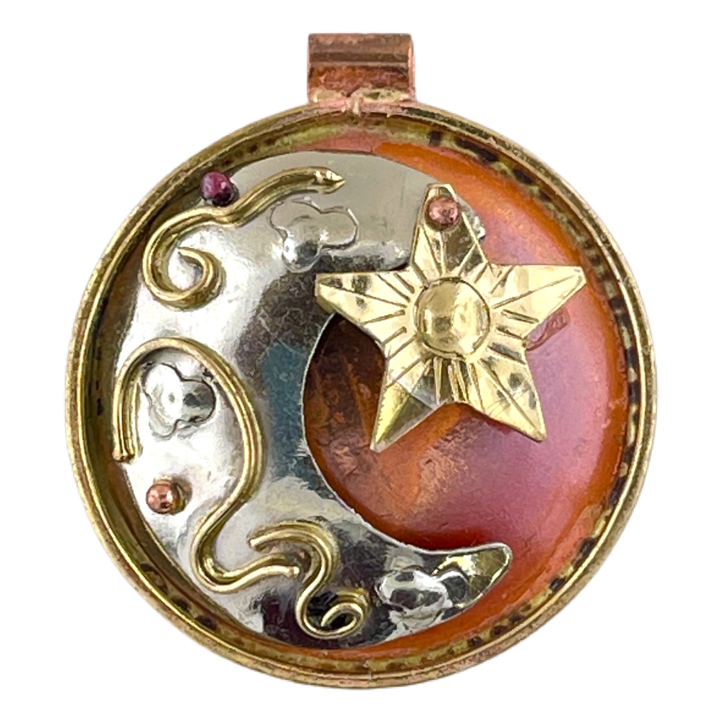 Handcrafted mixed metal eclipse pendant with red flame patina, featuring a domed copper sun, silver moon, and dangling brass star by Patricia Healey