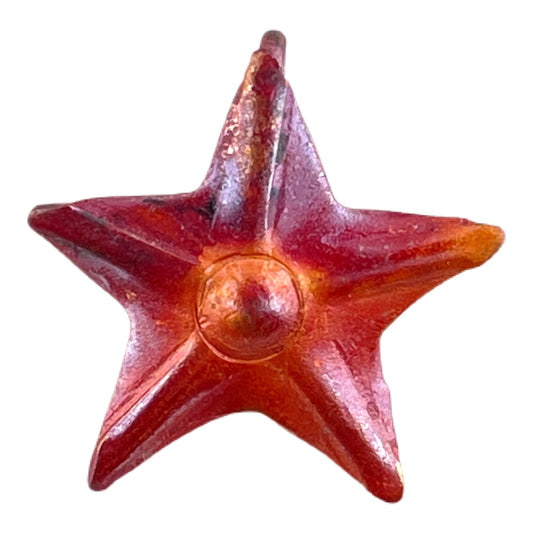 Small handmade copper star charm with repoussé texture and torch-fired red-orange patina by Patricia Healey