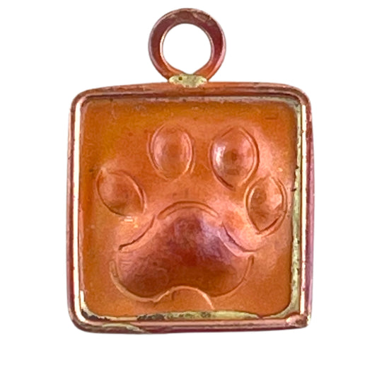 Copper paw print charm with red flame patina, handcrafted by Patricia Healey for cat and dog lovers.