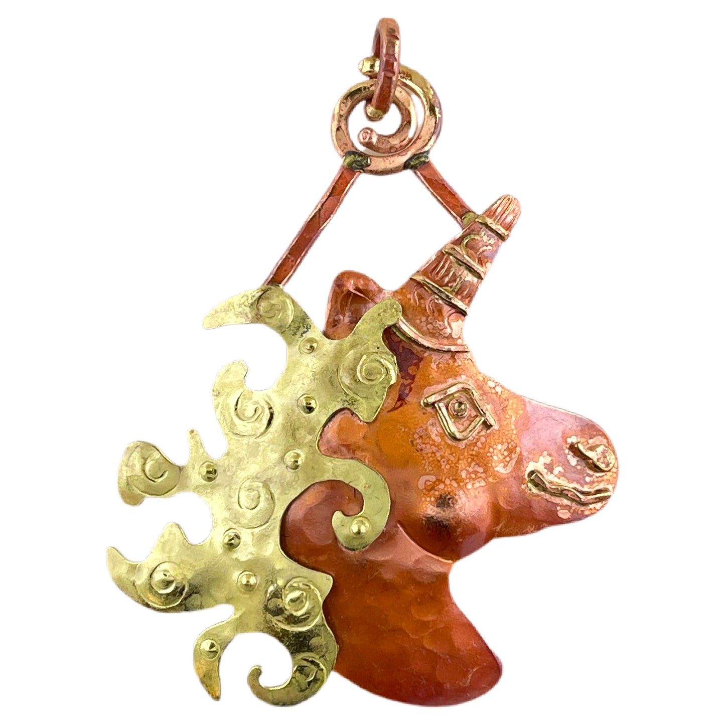 Handcrafted copper unicorn pendant with spiral-stamped mane, red flame patina, and brass accents by Patricia Healey