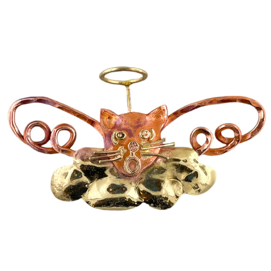 Handcrafted copper angel cat pendant with brass halo and cloud detail, featuring a red flame patina and whimsical feline expression.