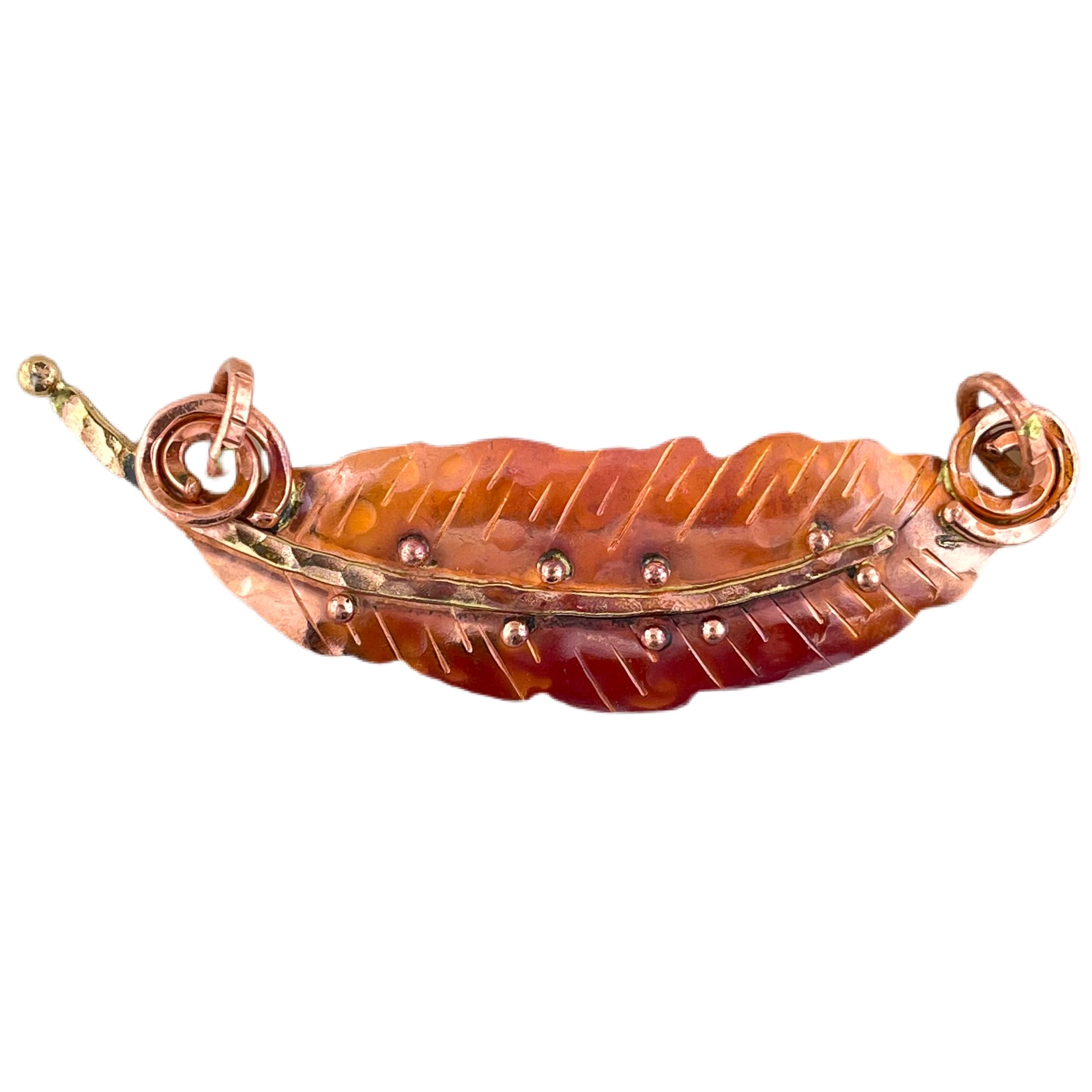 Horizontal copper feather pendant with spiral brass bails and red-orange flame patina