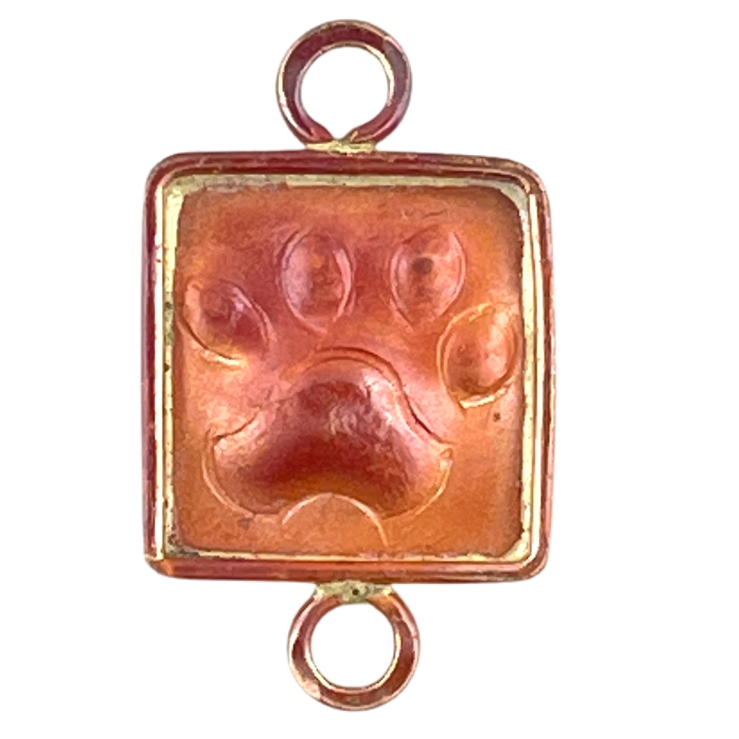 small copper paw print link with brass frame and two loops