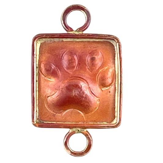 small copper paw print link with brass frame and two loops