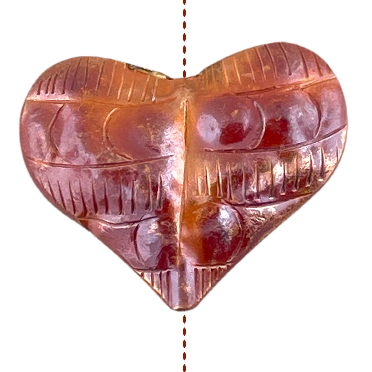 Handcrafted copper heart pendant with hand-stamped texture and red-orange flame patina