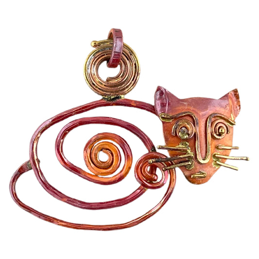 Curled copper cat pendant with sculpted brass whiskers and red flame patina, handcrafted by Patricia Healey with alert feline expression.