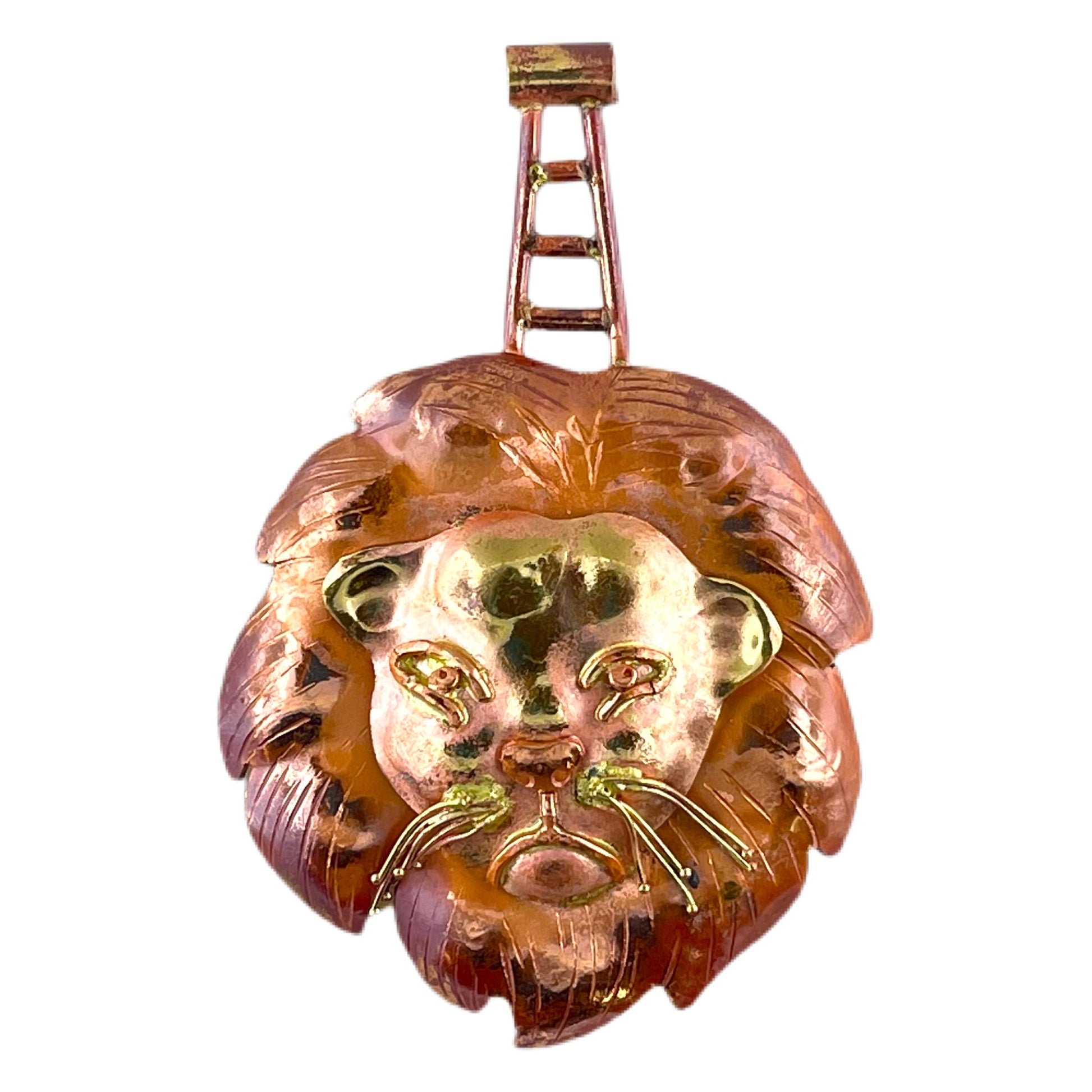 Handcrafted copper lion pendant with stamped brass face, red flame patina, and detailed whiskers by Patricia Healey