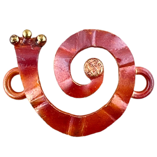 Copper and brass spiral jewelry link with soldered rings, flame-torched red patina