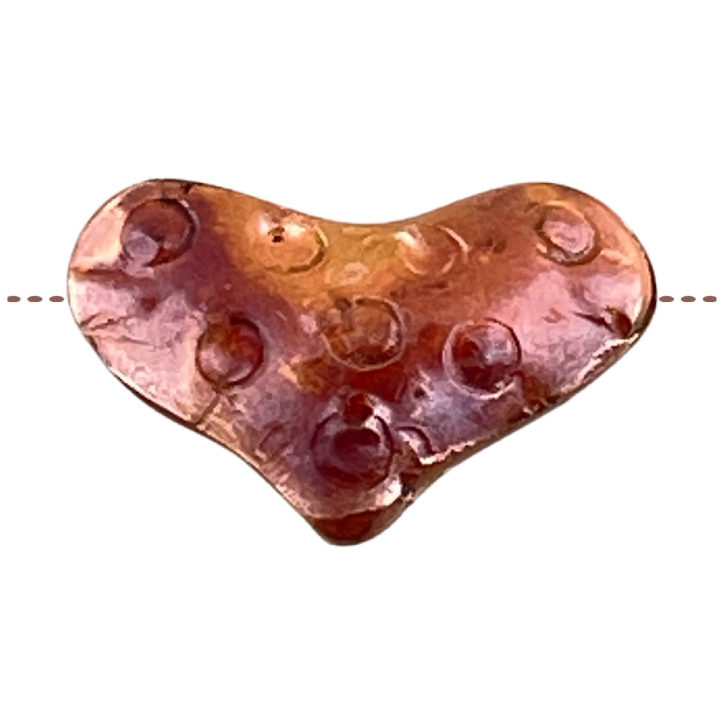 Side-drilled copper heart bead with red-orange flame patina and hand-stamped texture