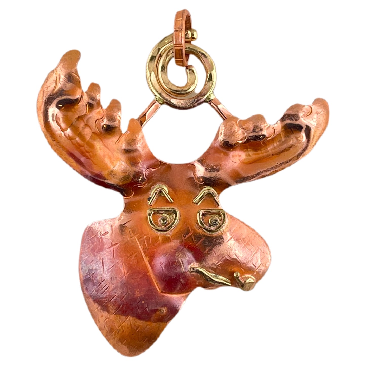 Handcrafted copper moose pendant with brass detail and red patina, featuring spiral bail and stamped texture by Patricia Healey