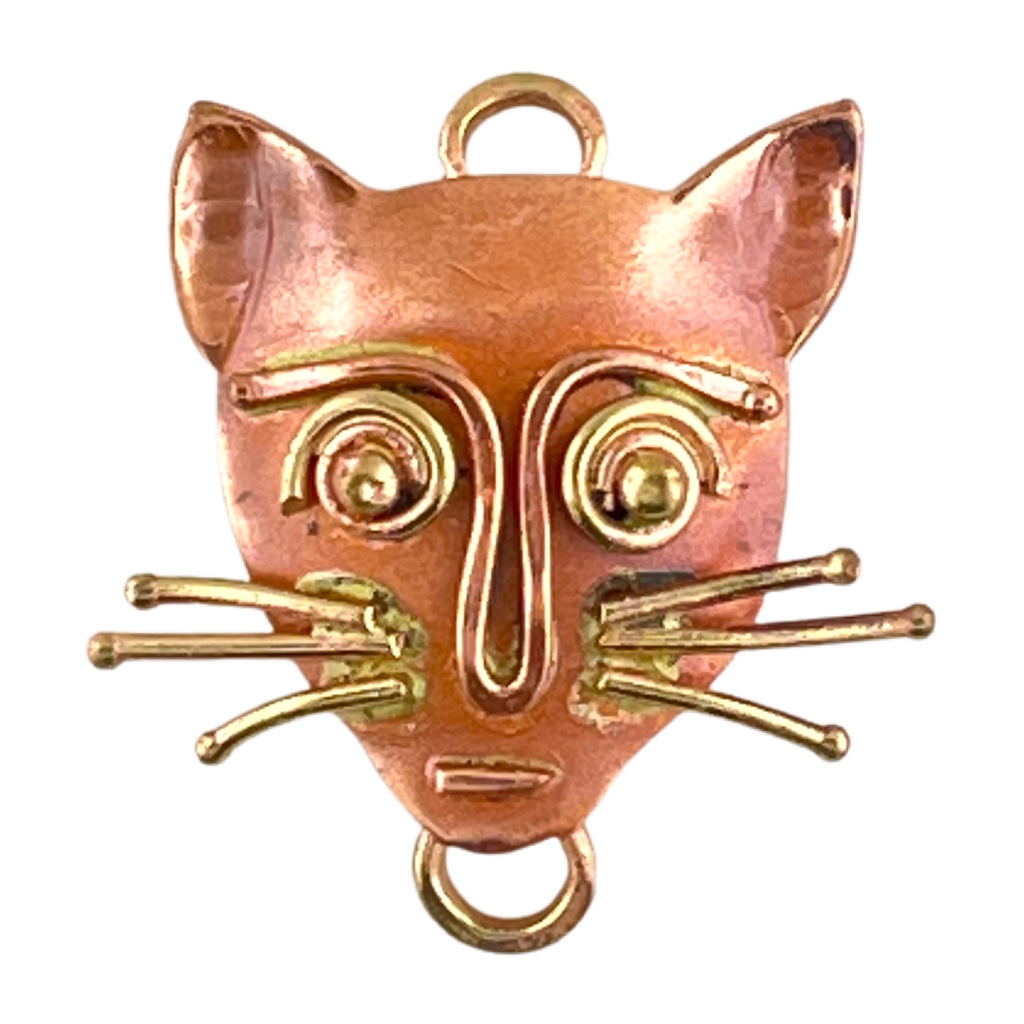 Small copper cat charm with brass whiskers and red flame patina, handcrafted by Patricia Healey for versatile jewelry designs.