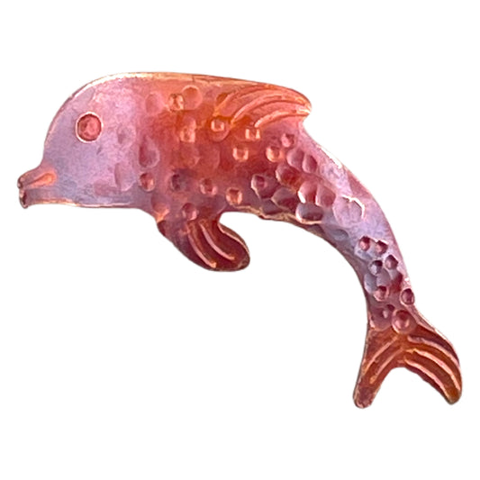 Left-facing copper dolphin charm with torch-fired red and orange patina, hand-stamped texture