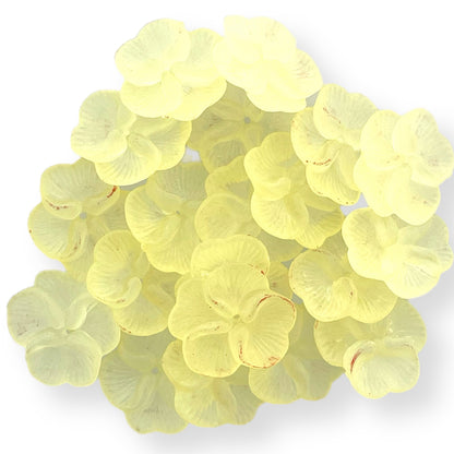 Set of 20 soft yellow translucent lucite flower beads with subtle red accents for jewelry making