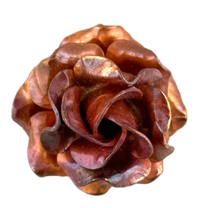Handmade small copper rose pendant with four hand-formed layers, red-orange torch-fired patina, and sculpted floral texture by Patricia Healey