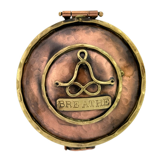 Handmade copper keepsake box with brass accents, meditation figure, infinity legs, and stamped word BREATHE

