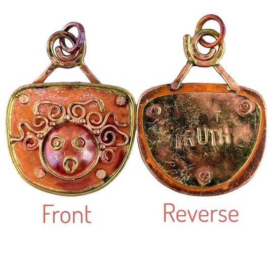 Reversible copper and brass pendant with wild-haired face and hand-stamped TRUTH