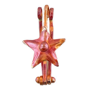 Handmade copper star donut bail with repoussé texture, red-orange torch-fired patina, and hinged mechanism by Patricia Healey