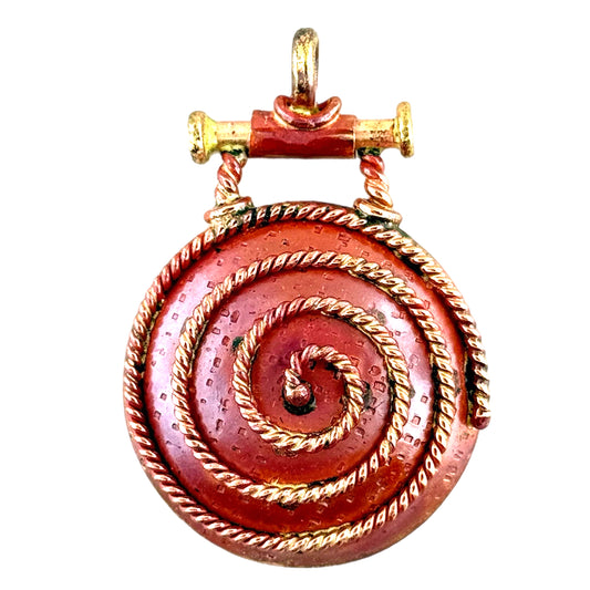 Handmade copper pendant with swing-style bail and tight spiral, faux brass screws, flame-torched red finish