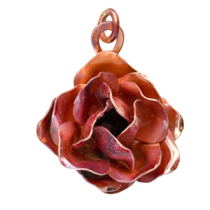 Handmade large copper rose pendant with repoussé form, red-orange flame patina, and sculpted texture by Patricia Healey