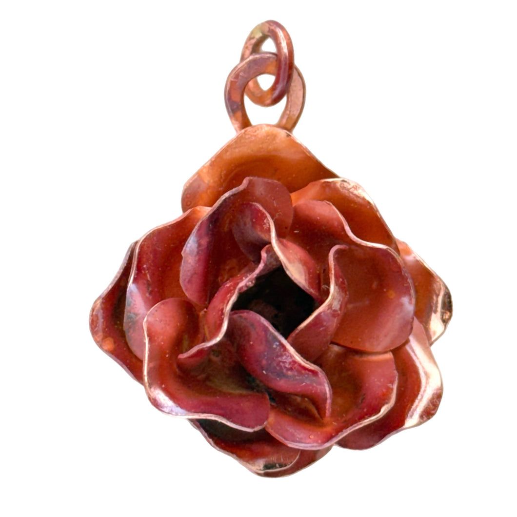 Handmade large copper rose pendant with repoussé form, red-orange flame patina, and sculpted texture by Patricia Healey