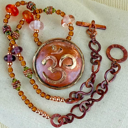 Handcrafted copper Om pendant necklace with brass accents and glass bead strand