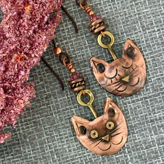 Handmade copper cat face earrings with brass accents, Swarovski crystal beads, and niobium ear wires by Patricia Healey Copper