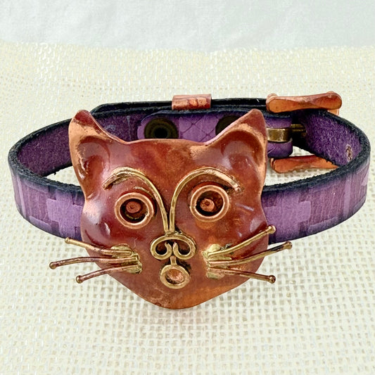 Handmade copper cat slider bracelet with brass whiskers, purple Greek leather strap, and copper brass buckle by Patricia Healey Copper