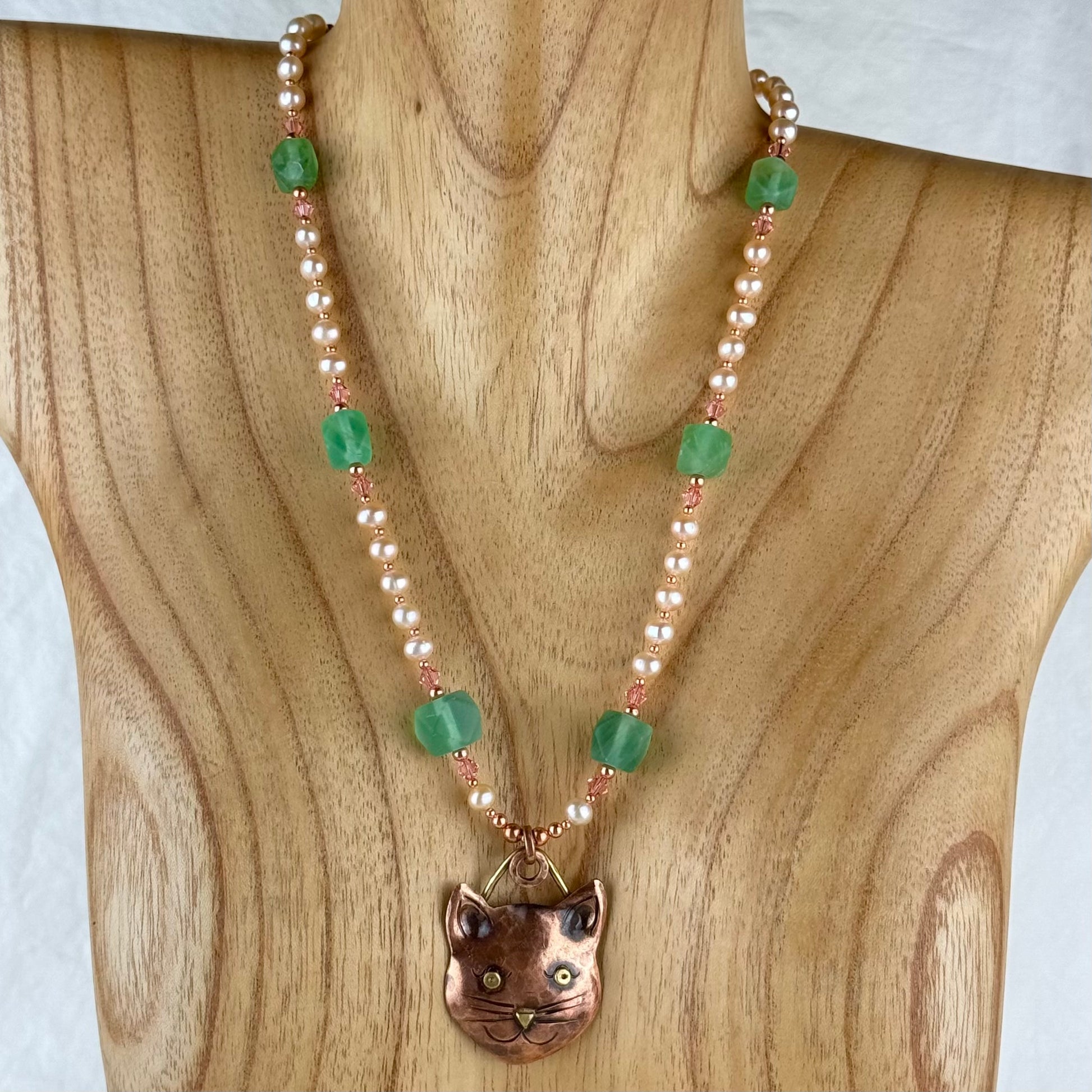 Handcrafted copper cat pendant necklace with freshwater pearls, green fluorite beads, and Swarovski crystal accents by Patricia Healey