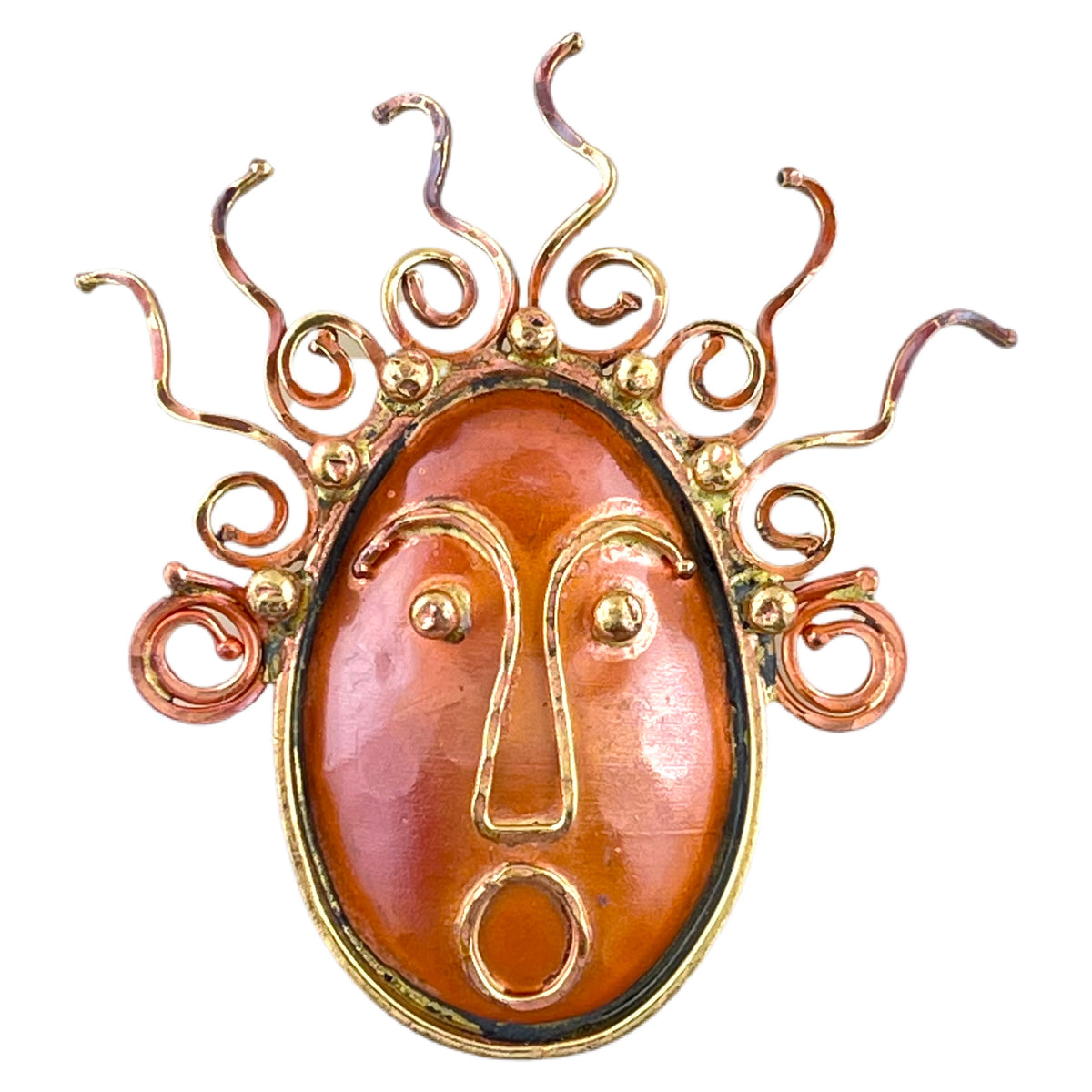 Handcrafted copper and brass pendant with spiral hair and wide-eyed face by Patricia Healey