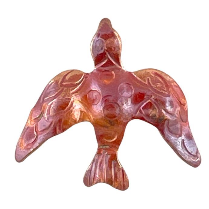 Handcrafted copper dove charm with bail on back, flame-finished in red and orange tones