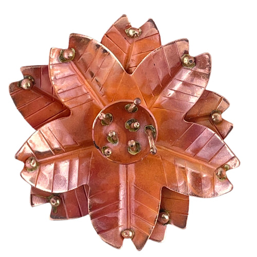Handmade copper flower pendant with three repoussé layers, stamped texture, and brass stamen detail by Patricia Healey