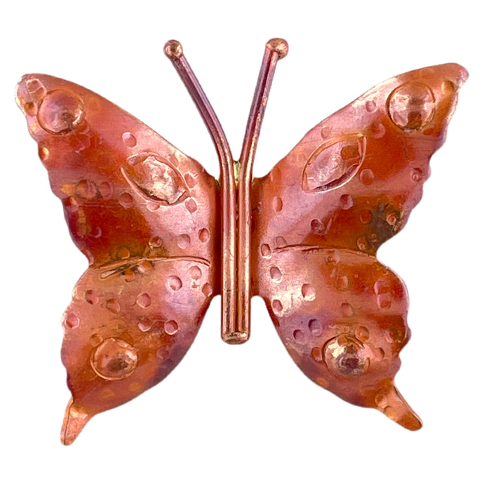 Handmade copper butterfly pendant with textured surface and flame-patinated finish