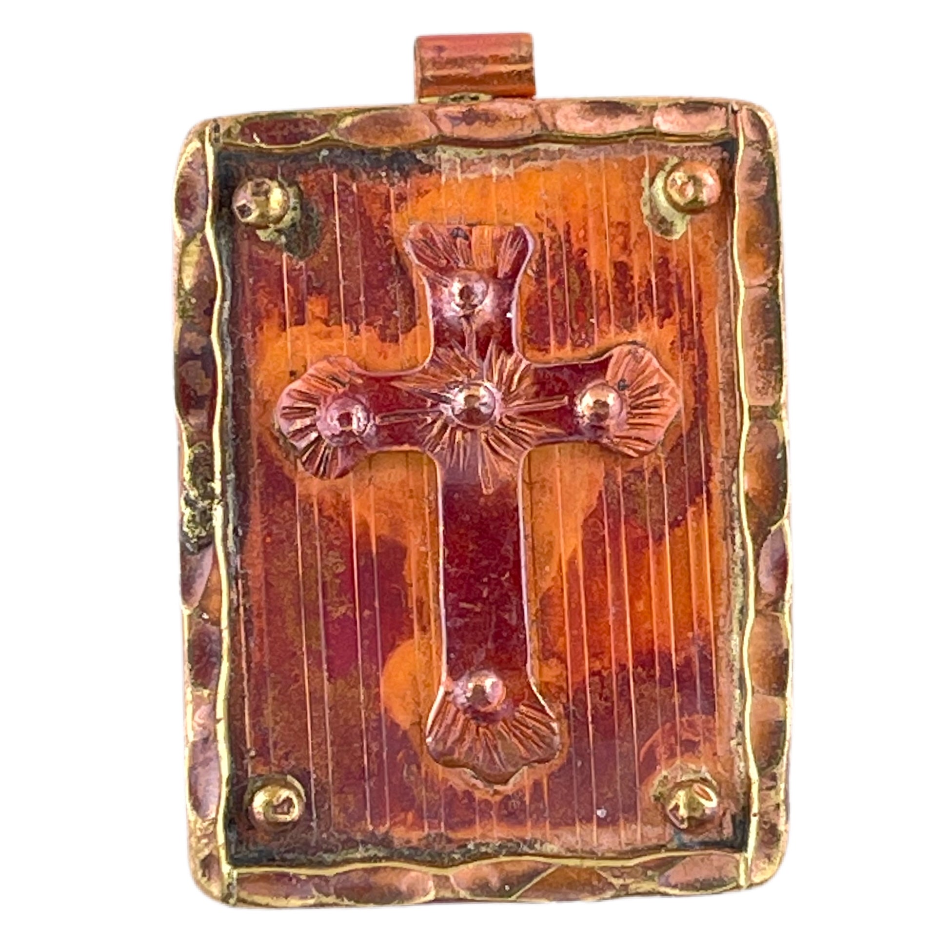 Copper cross on brass plaque pendant, flame-fired with red-orange patina and textured hand-stamped detail. Designed by Patricia Healey.