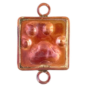 Copper paw charm with brass accents and red flame patina, handcrafted by Patricia Healey for earrings or pet-themed jewelry designs.