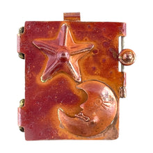 Handcrafted copper locket with repoussé moon and stars, red patina finish, brass accents, and secure closure by Patricia Healey