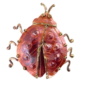 Handcrafted copper ladybug pendant with brass detailing, angled bail, and flame patina