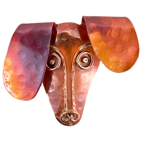 Copper Dachshund pendant with brass detail, red flame patina, and hammered repoussé texture