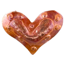 Small handcrafted copper heart pendant with red flame patina and dual ring bails, created by Patricia Healey using repoussé technique.
