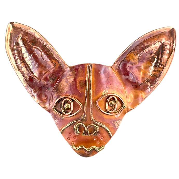 Handcrafted copper Chihuahua pendant with brass detail and red flame patina, designed by Patricia Healey for animal lovers and bold jewelry