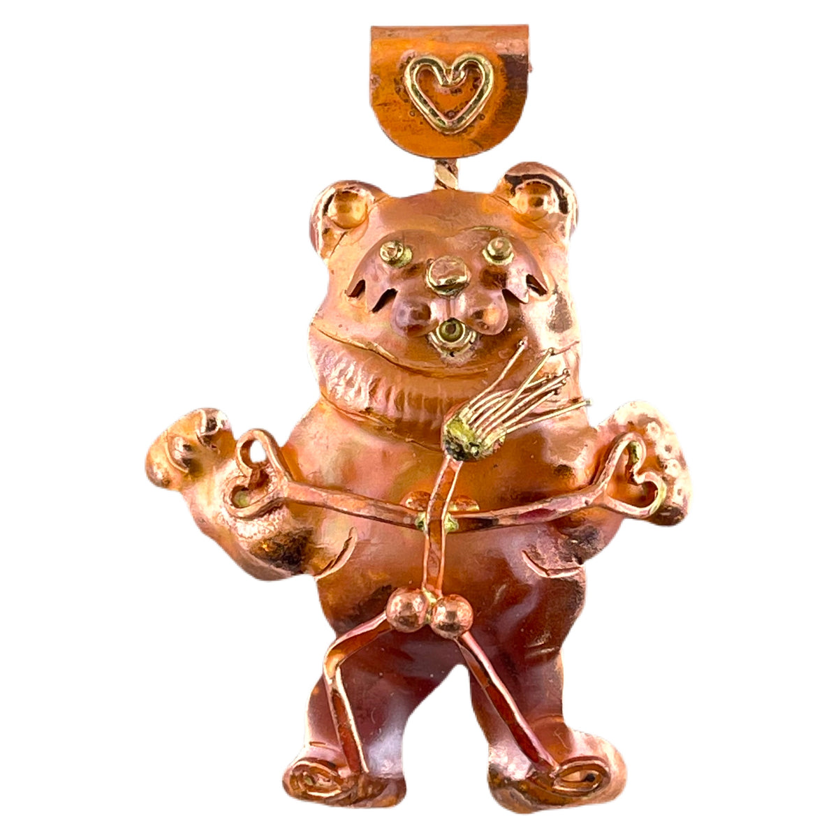 Handmade copper pendant with dancing bear and girl, brass accents, and heart-shaped hands by Patricia Healey