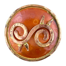 Copper Ahoden symbol pendant with brass accents, hammered texture, and flame-fired patina in red and orange tones. Designed by Patricia Healey.