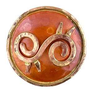 Copper Ahoden symbol pendant with brass accents, hammered texture, and flame-fired patina in red and orange tones. Designed by Patricia Healey.