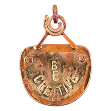 Reversible copper pendant with whimsical face on front and BE CREATIVE plaque on back, handmade by Patricia Healey